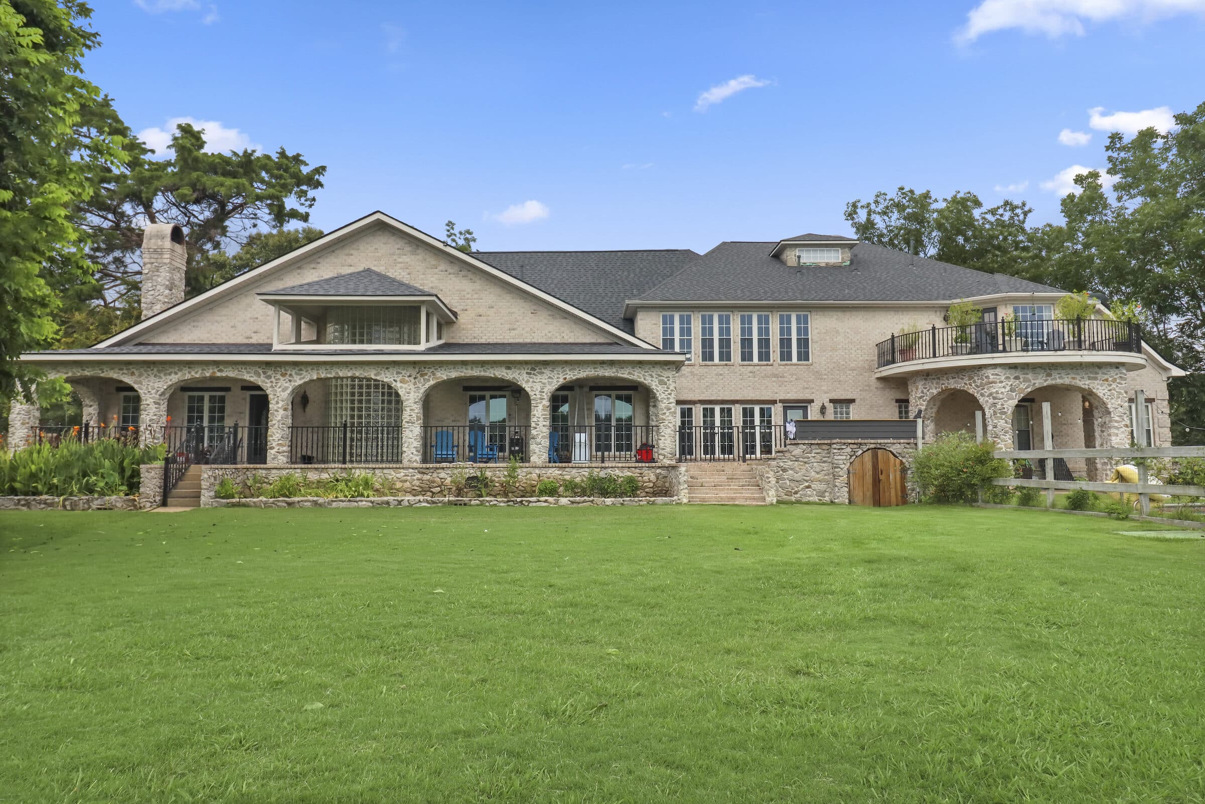 Long facade of an estate home across a manicured lawn