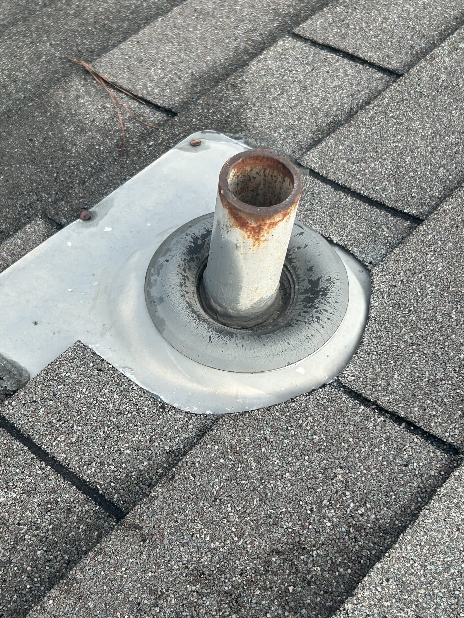 Close-up of a sealed pipe boot on architectural shingles